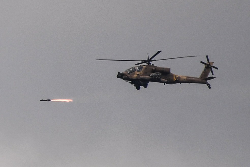 Um helicóptero Apache israelense dispara enquanto sobrevoa a fronteira entre Israel e Líbano — Foto: REUTERS/Gil Eliyahu