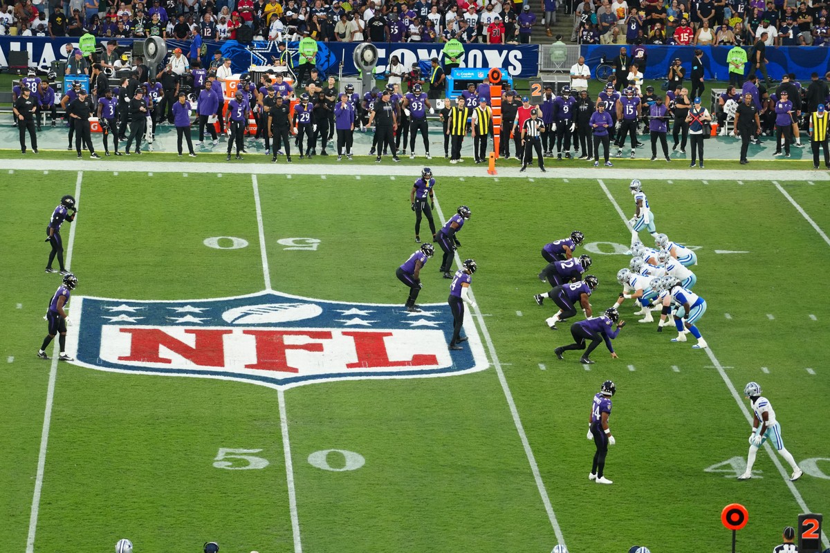 Players battling during the Ravens and Cowboys game in Brazil.