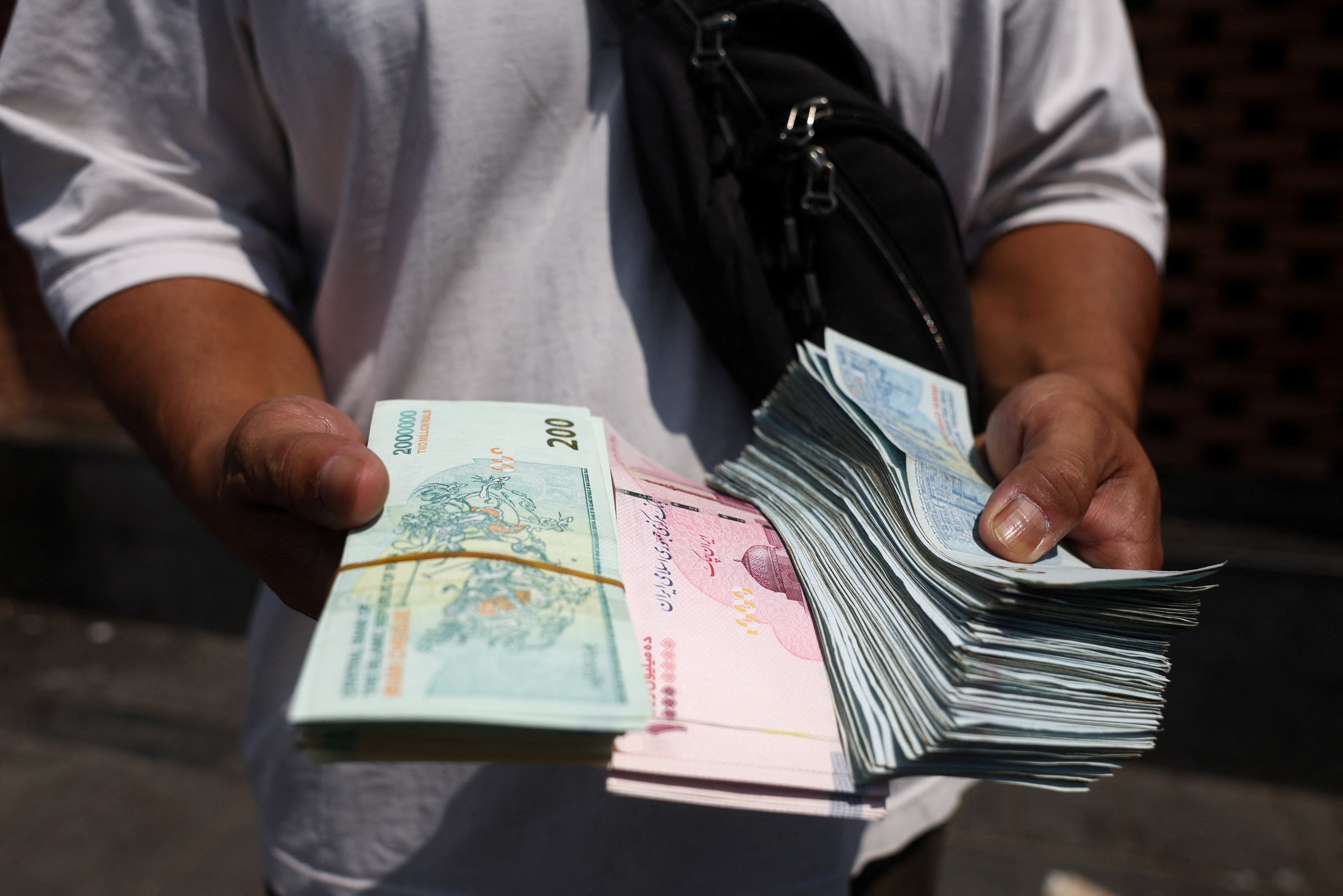 Moeda iraniana cai para nova mínima histórica de 2,2 milhões de riais por dólar - QTU Questões do Universo