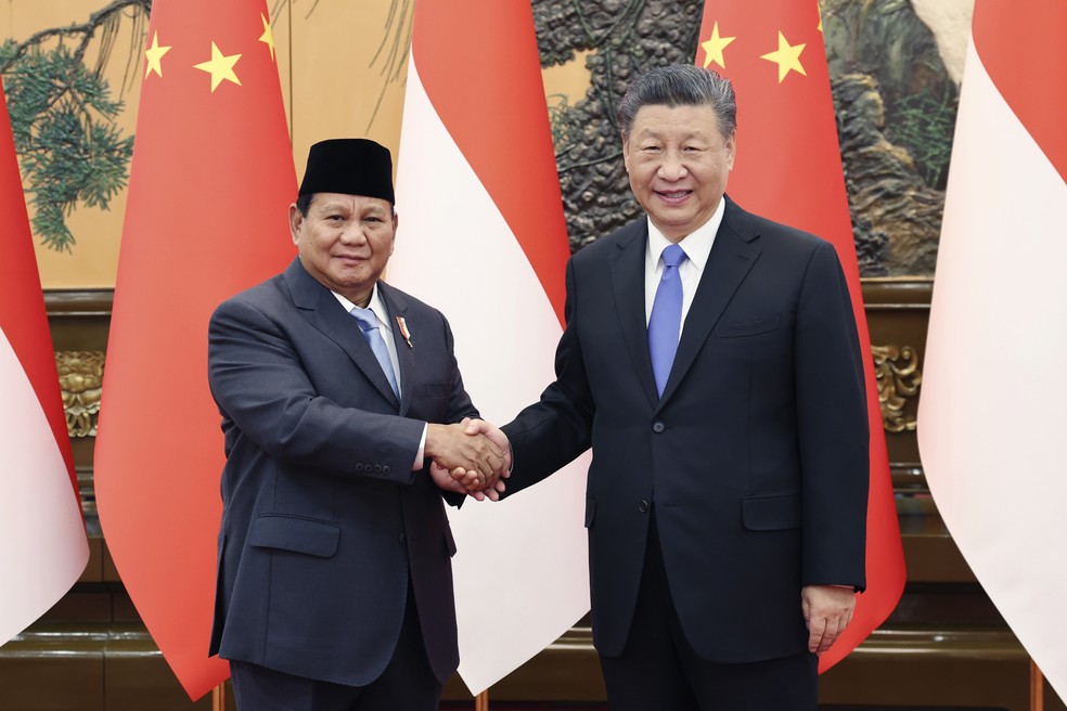 Presidente chinês Xi Jinping, à direita, aperta a mão do presidente eleito da Indonésia, Prabowo Subianto, no Grande Salão do Povo em Pequim — Foto: Yao Dawei/Xinhua via AP