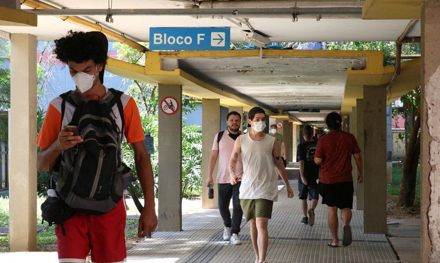 Pessoas caminham no campus da USP em São Paulo