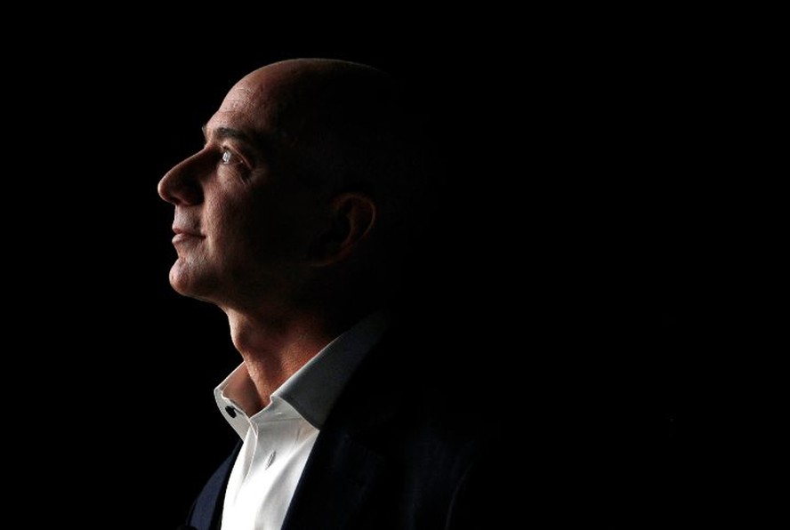 Jeff Bezos, chief executive officer of Amazon.com Inc., watches a video of the new Kindle Fire HD tablet at a news conference in Santa Monica, California, U.S., on Thursday, Sept. 6, 2012. Amazon.com Inc. is updating its line of Kindle e-readers and table