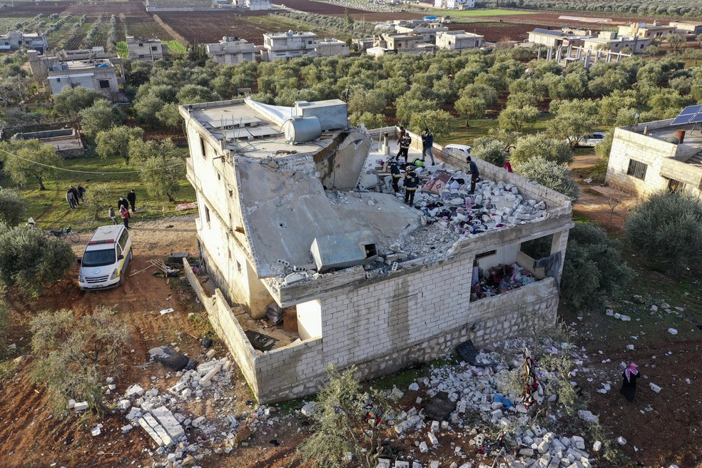 Pessoas inspecionam uma casa destruída após uma operação militar dos EUA; principal líder do grupo Estado Islâmico, Abu Ibrahim al-Hashimi al-Qurayshi foi morto na operação — Foto: Ghaith Alsayed/AP